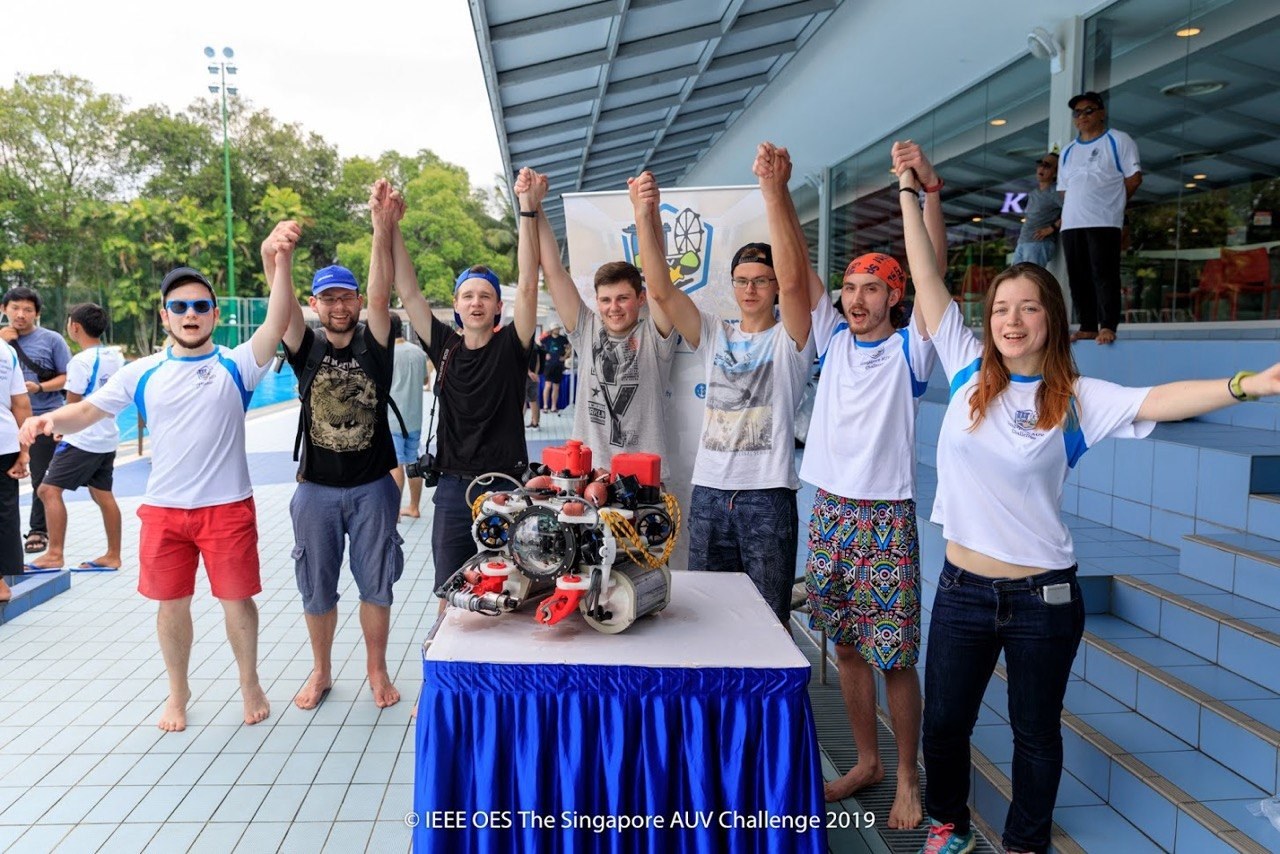 Hydranautics team celebrating at SAUVC 2019 with an autonomous underwater robot